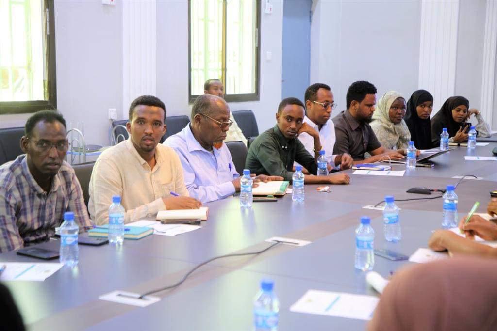 Diverse group of professionals collaborating over a map on a table